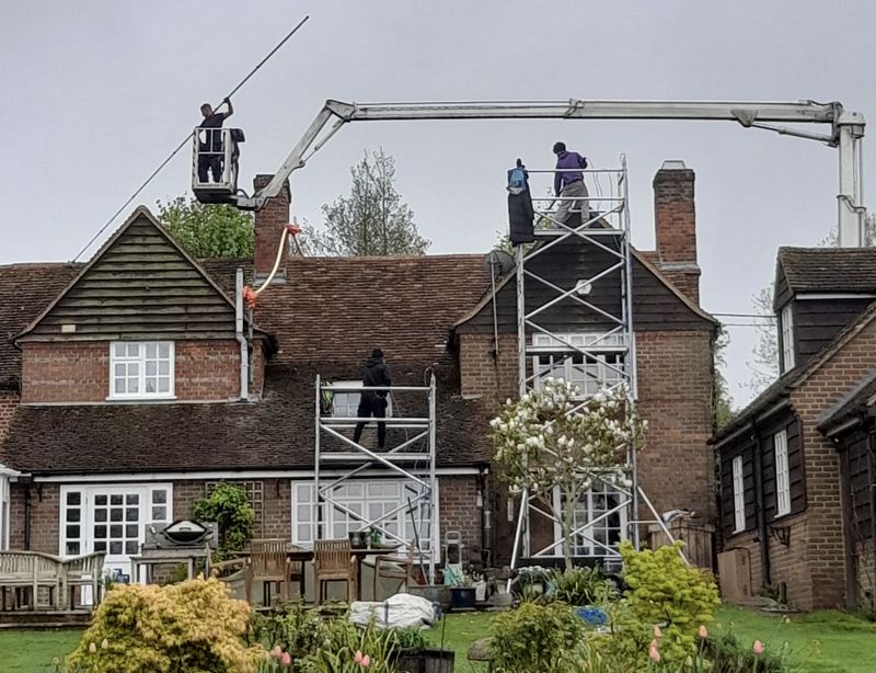 The Roof Moss Cleaners using cherry picker and scaffolding to clean roof safely and professionally in Thornbury, Gloucestershire